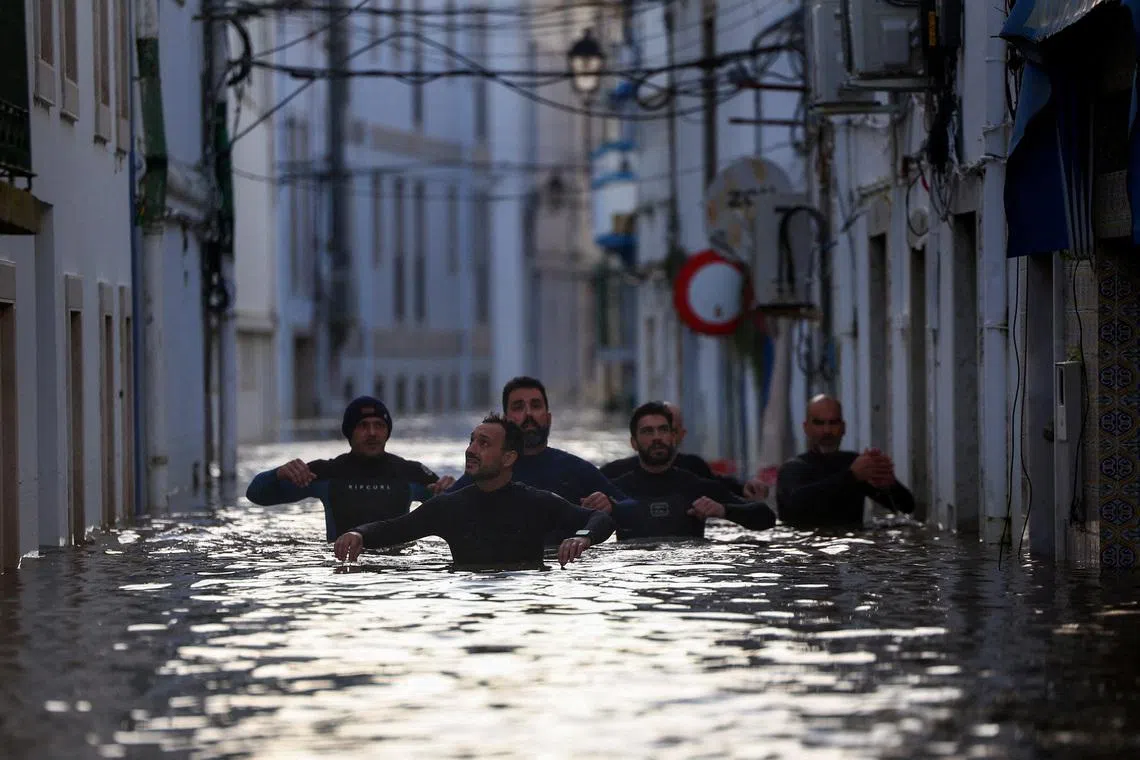 Volunteers wading through a flooded street looking for survivors after storm Leo passed by Alcacer do Sal, Portugal on Feb 5, 2026. 