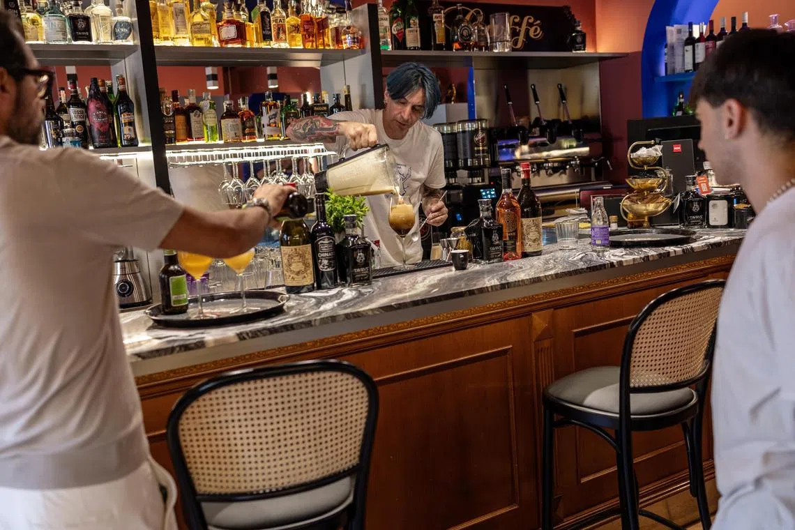 A server pours a caffè shakerato, an espresso-based drink, at Cicinin in Turin, Italy, June 25, 2025. The high price of beans has put coffee bars in a bind in Italy, where the drink is a ritual and customers demand cheap espresso. (Fabio Bucciarelli/The New York Times)