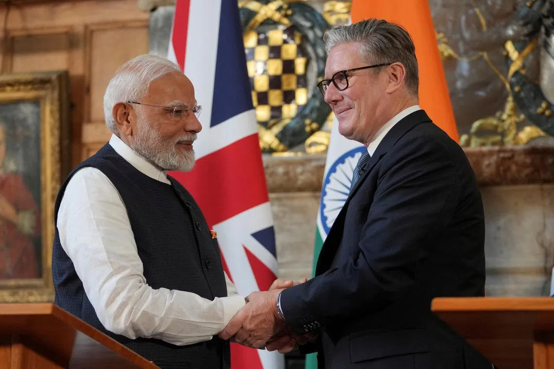 Britain's Prime Minister Keir Starmer and Prime Minister Narendra Modi of India shake hands after signing a free trade agreement at Chequers near Aylesbury, England, Thursday, July 24, 2025.    Kin Cheung/Pool via REUTERS