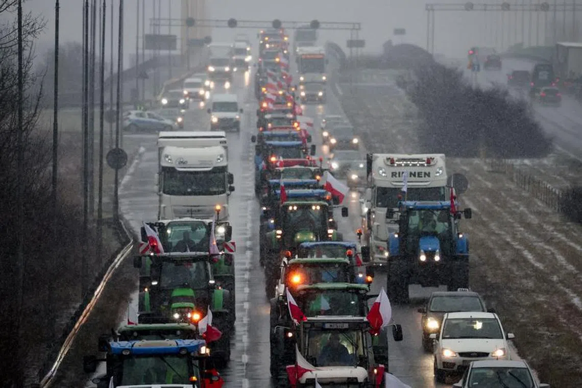 Polish farmers slow down traffic on a road with tractors during a protest over price pressures, taxes and green regulation, grievances shared by farmers across Europe, in Poznan, Poland, February 9, 2024. REUTERS/Kacper Pempel