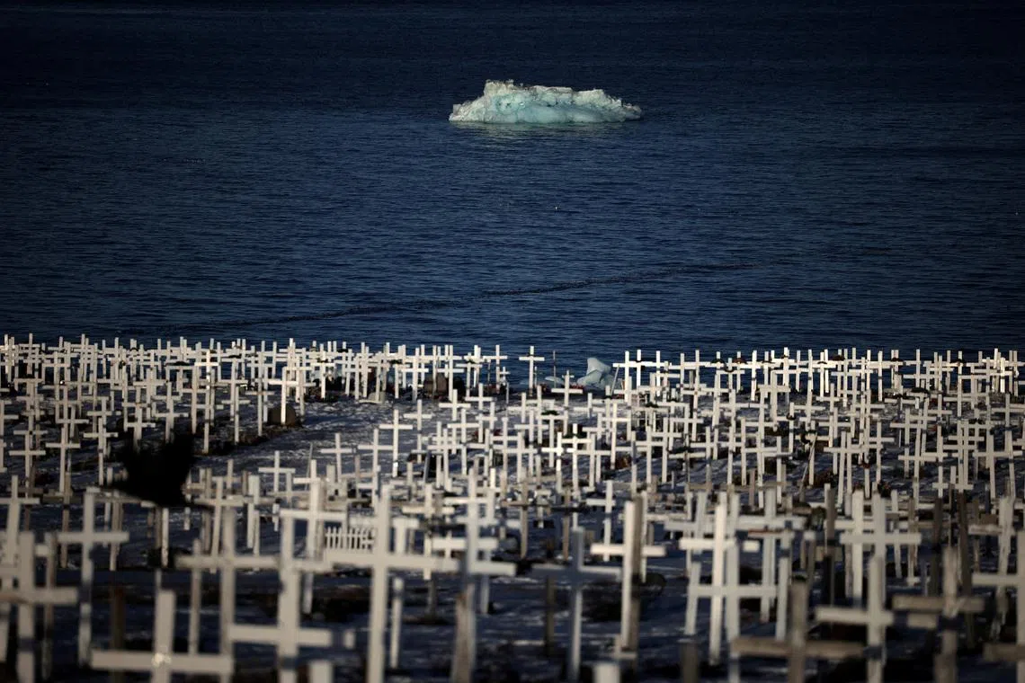An ice block floating in the sea waters near a cemetery in Nuuk, Greenland in a photo which was released on Feb 4, 2026.