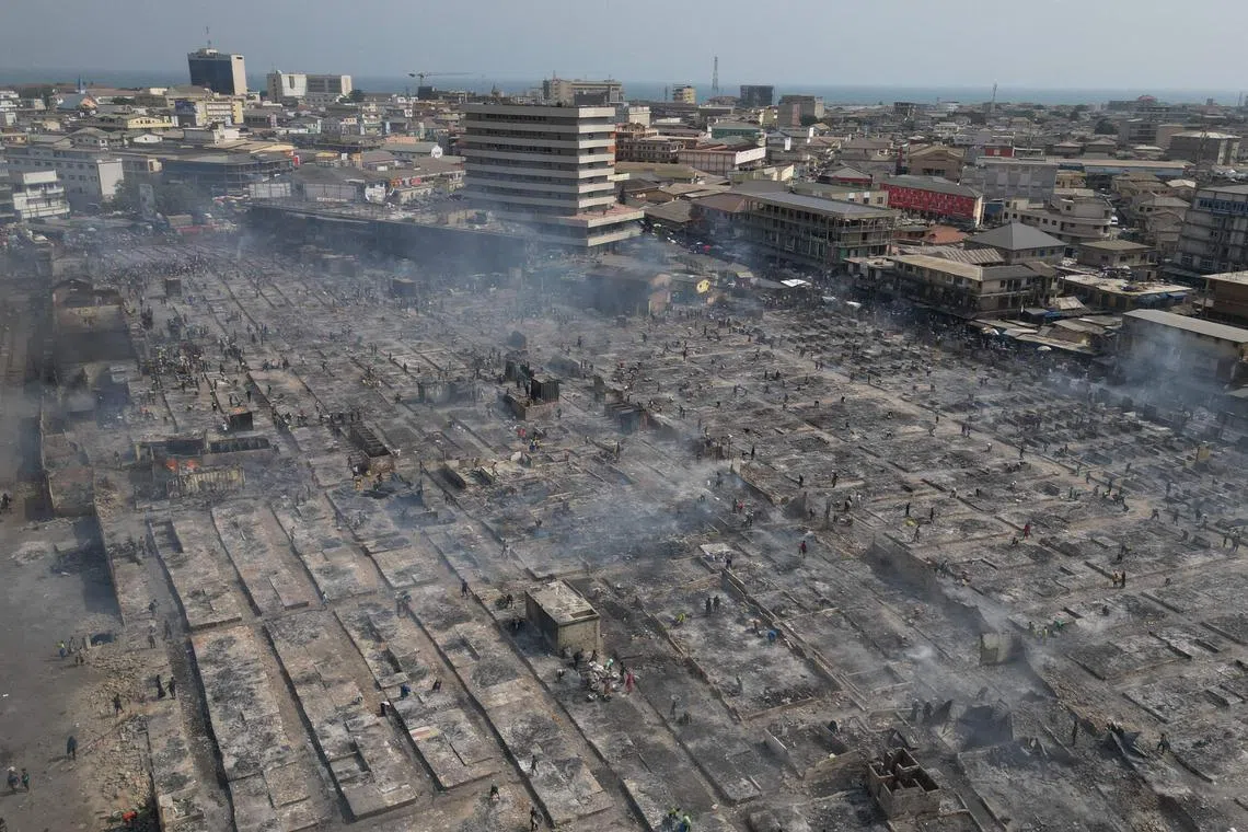 Aerial shot showing people trying to salvage items from the burned down secondhand clothing market at Kantamanto in Accra, Ghana on Jan 2, 2025. The fire at the Kantamanto market began in the early morning hours, destroying a large part of the area and displacing thousands of traders. 