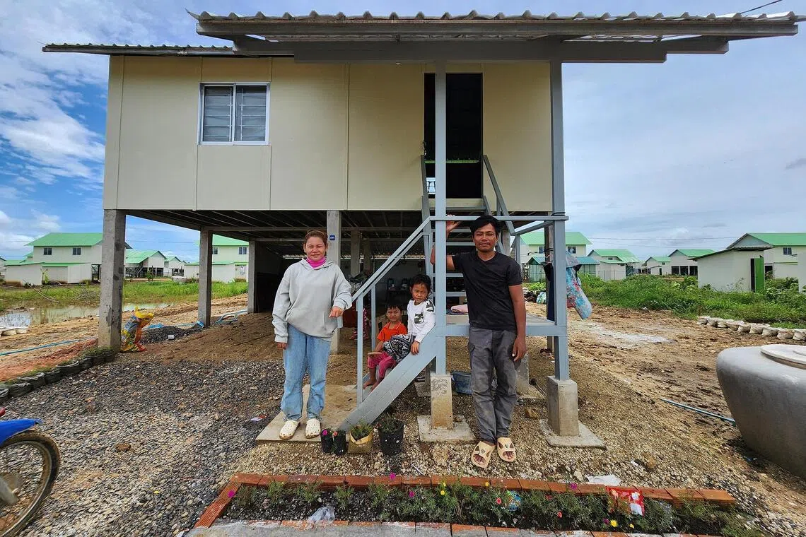 Sun Samnoeun, who lost her house and land in the Thai-Cambodian border conflict, with her husband and children at their temporary home set up by the Cambodian government for those displaced.