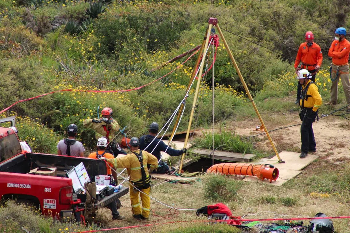Members of a rescue team work at a site where three bodies were found in the state of Baja California where one American and two Australian tourists were reported missing, in La Bocana, Mexico May 3, 2024. REUTERS/Francisco Javier Cruz