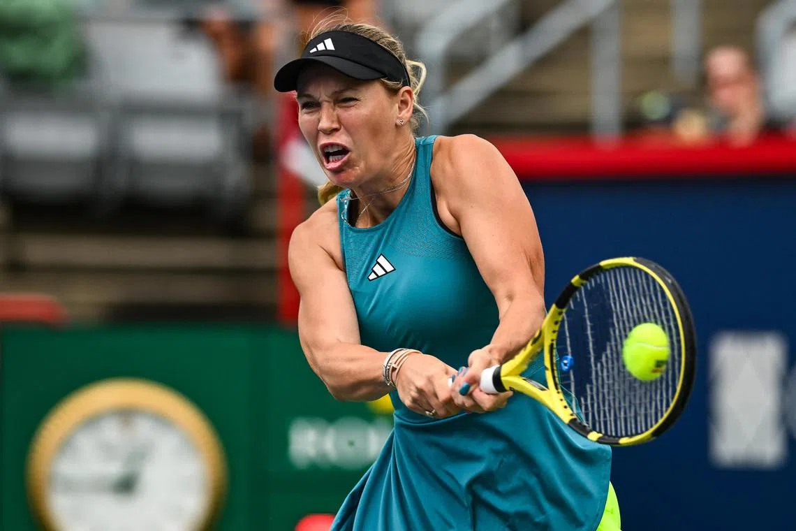 Denmark's Caroline Wozniacki hits a return against Kimberly Birrell of Australia.