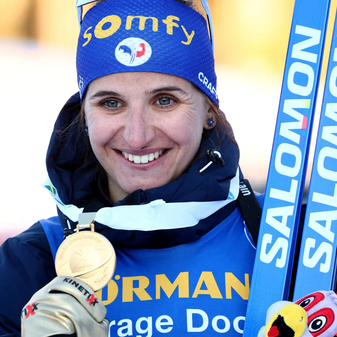 FILE PHOTO: Winter Sports - Biathlon World Championships - Lenzerheide, Switzerland - February 18, 2025 Gold medallist France's Julia Simon celebrates on the podium after winning the Women's 15km Individual REUTERS/Denis Balibouse/File Photo