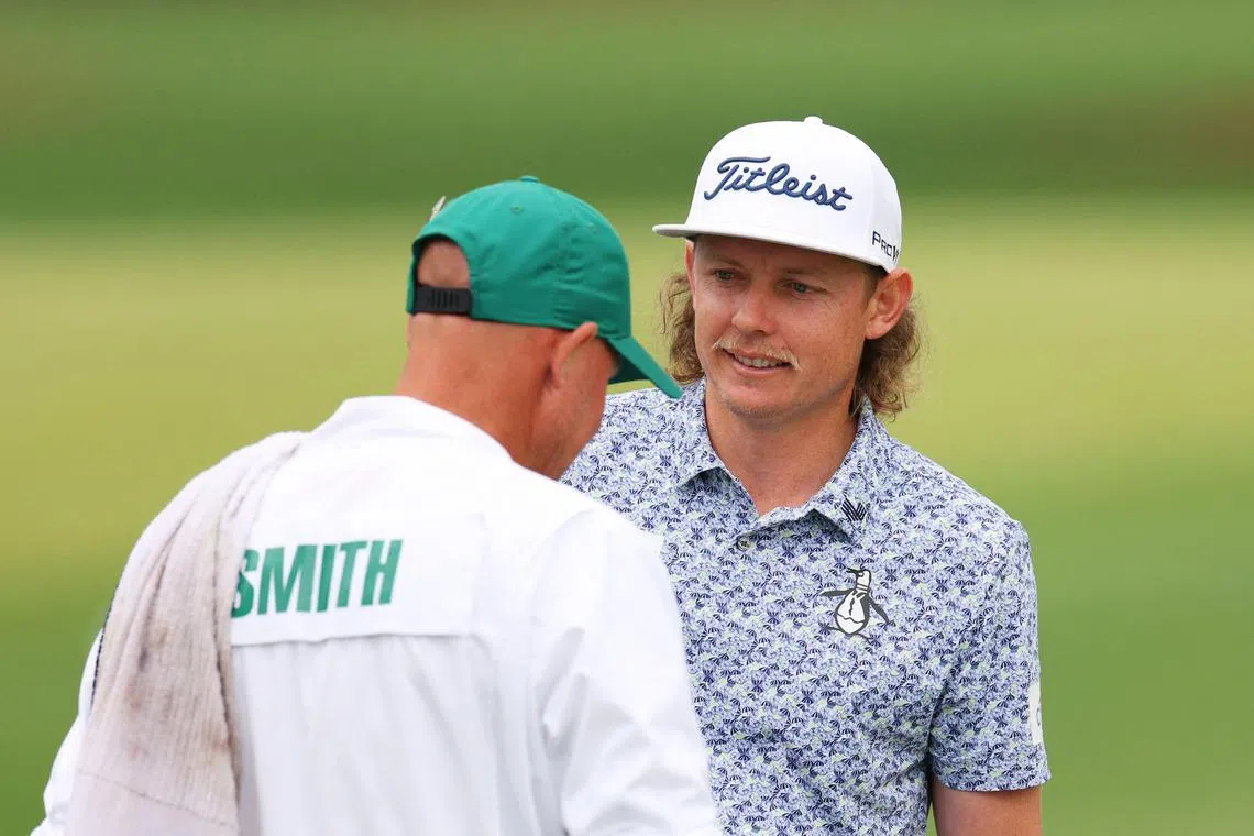 Cameron Smith talking with his caddie Sam Pinfold at the practice area ahead of the Masters at Augusta National.