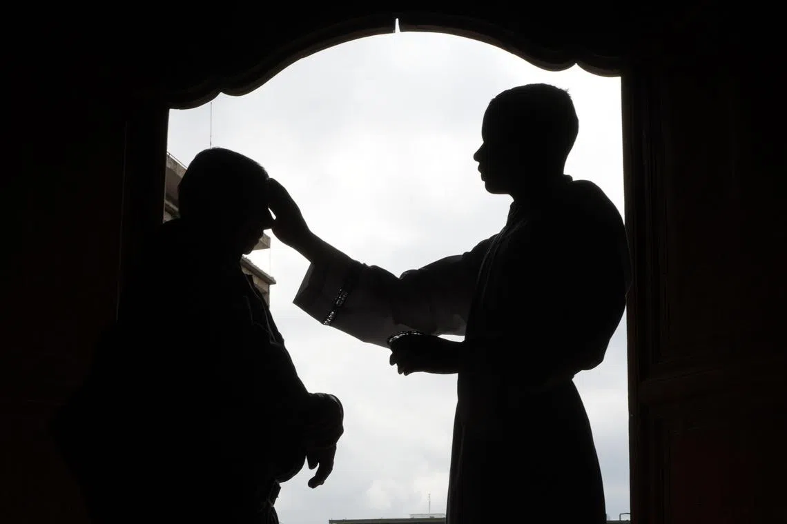 A worshipper receiving the imposition of ashes on a person on Ash Wednesday, at the Church of San Francisco in Cali, Colombia, Feb 18, 2026. 