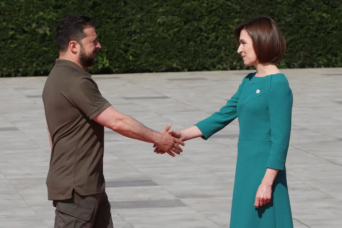 File photo: Ukraine's President Volodymyr Zelenskiy shakes hands with Moldova's President Maia Sandu at a welcome ceremony during a meeting of the European Political Community at Mimi Castle in Bulboaca, Moldova June 1, 2023. REUTERS/Vladislav Culiomza/File photo