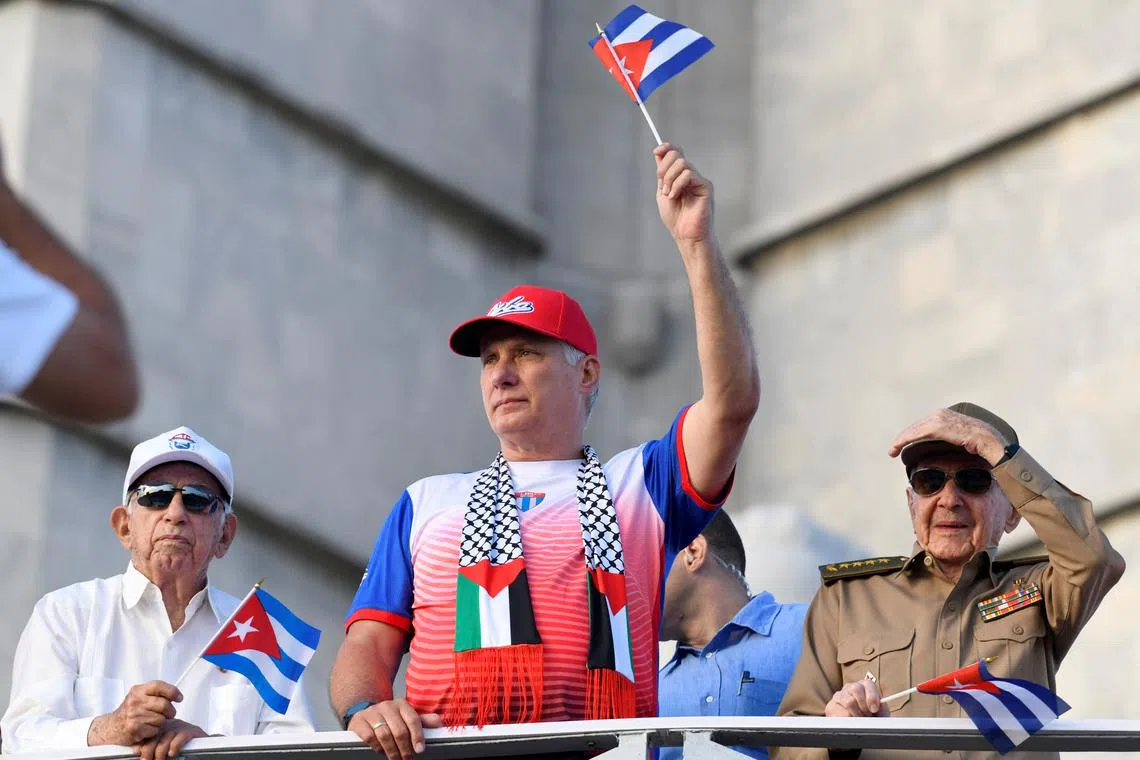 Cuba's former President Raul Castro, Cuba's President and First Secretary of the Communist Party Miguel Diaz-Canel and Cuba's former Vice President Jose Ramon Machado watch a May Day rally in Havana, Cuba May 1, 2025. REUTERS/Norlys Perez