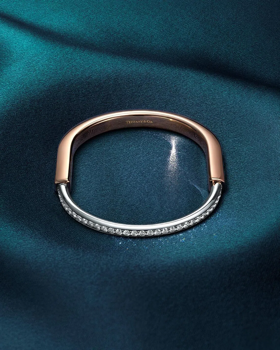 Tiffany Lock bangle in rose and white gold with half pave diamonds.