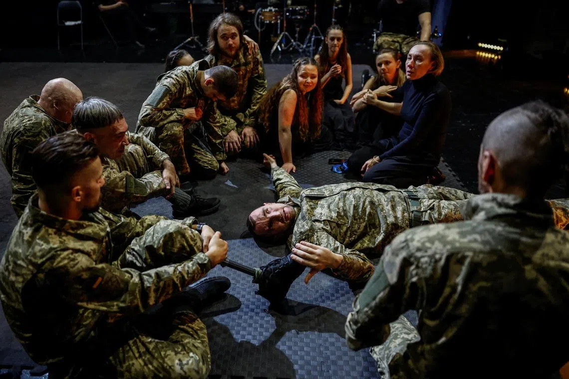 Olha Semoshkina (top right), chief choreographer of the Veterans' Theatre group, talks to the actors before the premiere of an 18th‑century Ukrainian parody of Virgil's \"Aeneid\", amid Russia's attack on Ukraine, in Kyiv, Ukraine, December 4, 2025. Fellow member and veterans' psychologist Yehor Babenko, 27, said the transformative trauma of serious injury often compels people to seek meaning in something new. He said it was critical for his fellow comrades to understand that life does not simply end after a serious injury. \"Sometimes, you understand it’s the opposite - that it just starts getting going.\" REUTERS/Alina Smutko
