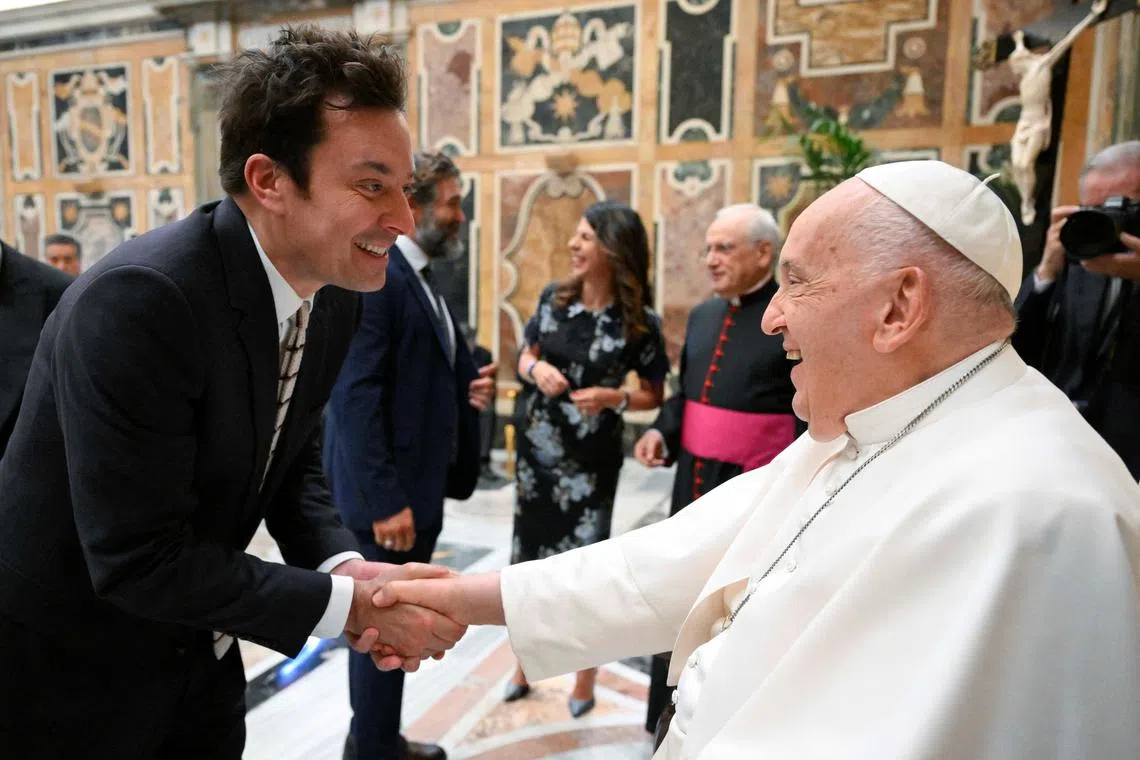 Pope Francis greets Jimmy Fallon as he meets with comedians during a cultural event at the Vatican, June 14, 2024. Vatican Media/­Handout via REUTERS    ATTENTION EDITORS - THIS IMAGE WAS PROVIDED BY A THIRD PARTY. BEST QUALITY AVAILABLE.