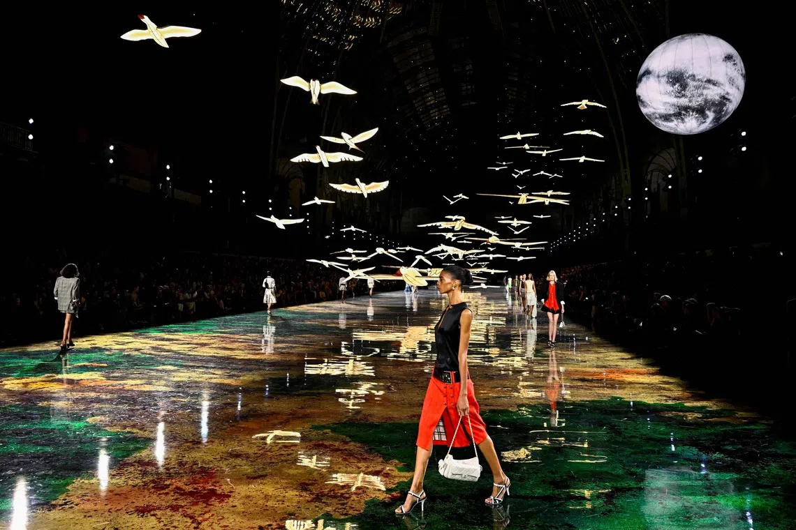 TOPSHOT - Models present creations for Chanel Women's Spring/Summer 2027 collection fashion show as part of the Paris Fashion Week, in Paris on October 5, 2026. (Photo by JULIEN DE ROSA / AFP)