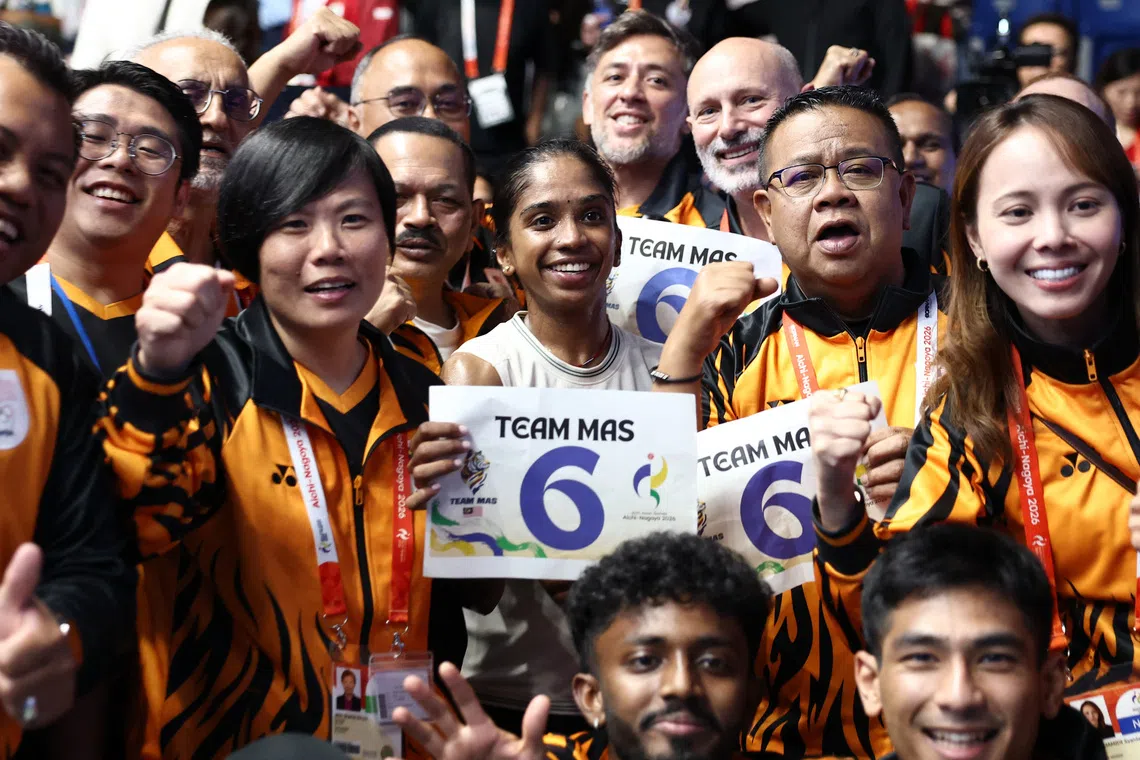 Asian Games - Aichi-Nagoya 2026 - Squash - Takeda Teva Ocean Arena, Nagoya, Japan - September 27, 2026 Malaysia's Sivasangari Subramaniam celebrates with teammates after winning the Women's Singles Gold Medal Match against India's Anahat Singh REUTERS/Chalinee Thirasupa