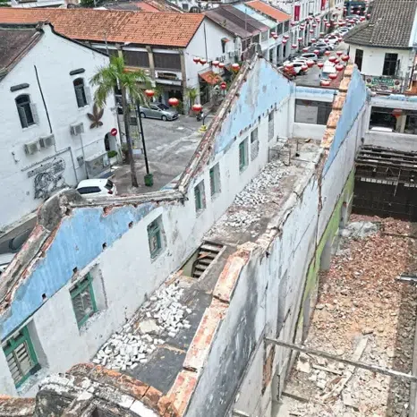 An aerial view showing pre-war houses demolished at Lebuh China in George Town, Penang, leaving only skeletal structures behind. 