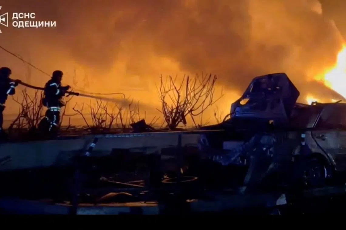 Firefighters work to control a fire in a location given as Odesa, Ukraine, after a Russian drone attack damaged energy infrastructure in Ukraine's Black Sea port of Odesa, triggering power cuts in the city and knocking out heating systems, according to local officials, in this screengrab taken from a handout video released on March 4, 2025/Handout via REUTERS/File Photo