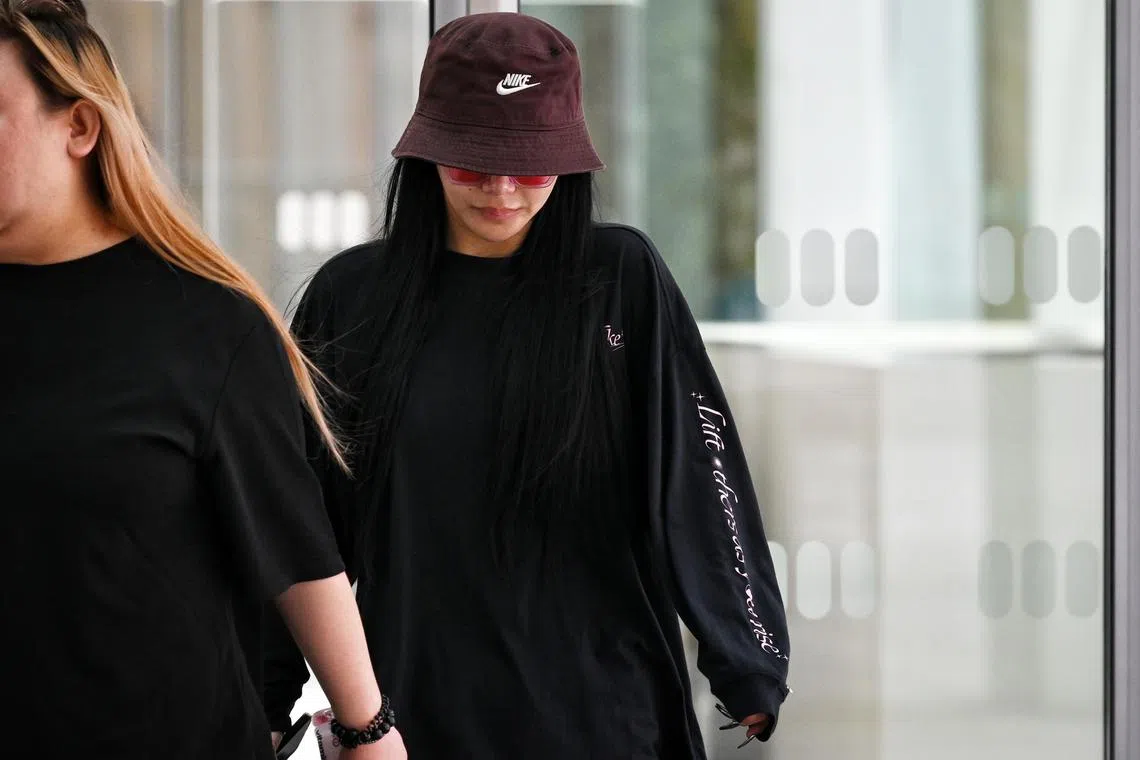 ST20230523_202302295792 Kua Chee Siong/ lckim23/ Socialite Kim Lim leaving the State Courts with escorts on May 23, 2023. She turned up in court to show support of her ex-husband Kho Bin Kai who was arrested for his involvement in an illegal gambling syndicate. She was previously pictured with Kho in an Instagram Story posted by actress Rebecca Lim celebrating her father's birthday.