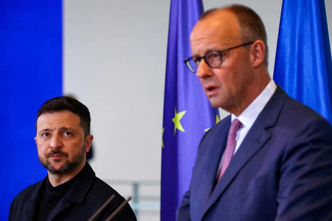 FILE PHOTO: German Chancellor Friedrich Merz and Ukraine's President Volodymyr Zelenskiy attend a press conference, at the Chancellery in Berlin, Germany, May 28, 2025.REUTERS/Fabrizio Bensch/File Photo