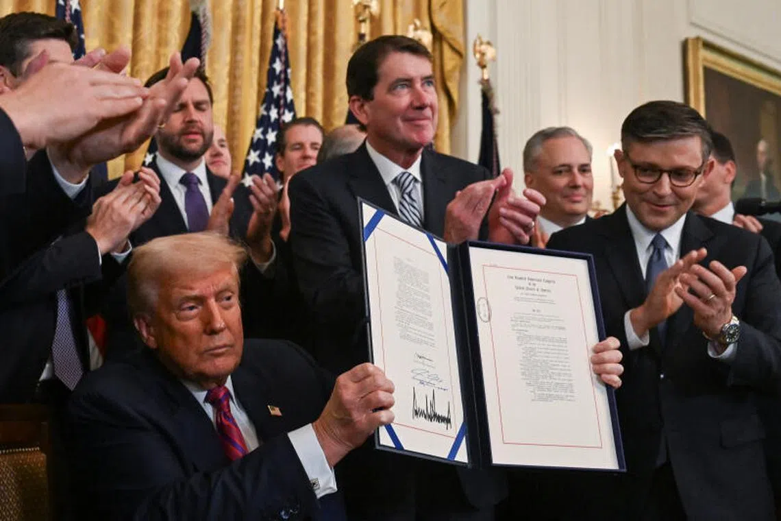 Caption:
U.S. President Donald Trump holds the signed "Genius Act", which will develop regulatory framework for stablecoin cryptocurrencies and expand oversight of the industry, at the White House in Washington, D.C., U.S., July 18, 2025. REUTERS/Annabelle Gordon