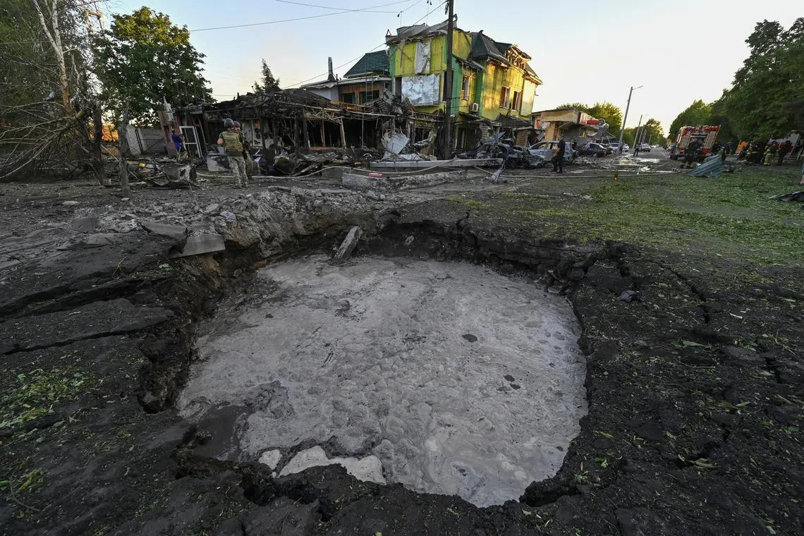 A crater that appeared after a Russian missile strike is seen in the town of Vilniansk, in Ukraine's Zaporizhzhia region.