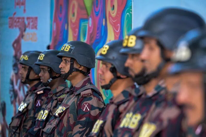Border Guard Bangladesh personnel standing guard along a road in Dhaka on Nov 16, ahead of the court's verdict in a case against fugitive ex-prime minister Sheikh Hasina.