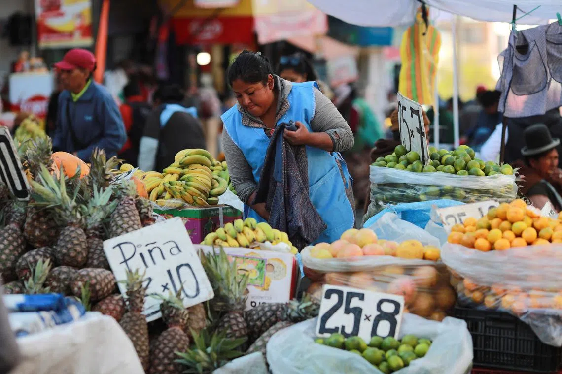 A street seller waits for customers along a street, after a failed coup attempt by the Bolivian armed forces, in La Paz, Bolivia June 29, 2024. REUTERS/Henry Romero/ File Photo