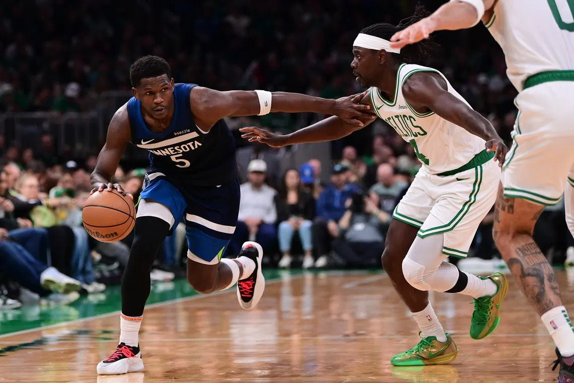 FILE PHOTO: Nov 24, 2024; Boston, Massachusetts, USA; Minnesota Timberwolves guard Anthony Edwards (5) drives the ball against Boston Celtics guard Jrue Holiday (4)  during the second half at TD Garden. Mandatory Credit: Eric Canha-Imagn Images/File Photo