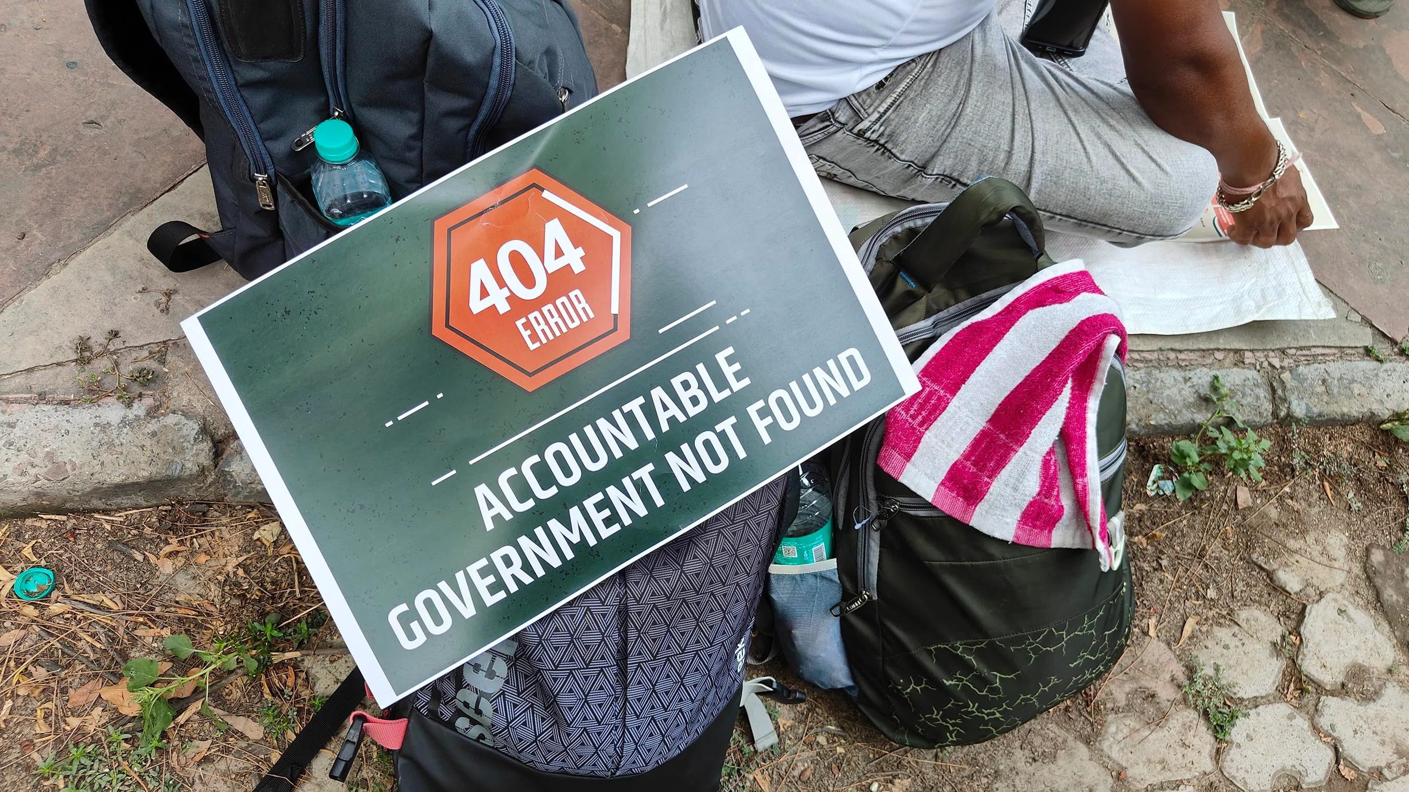 A poster at the protest in Delhi that reads “Accountable Government Not Found”, with the common “404 Error” symbol that represents a broken link online.