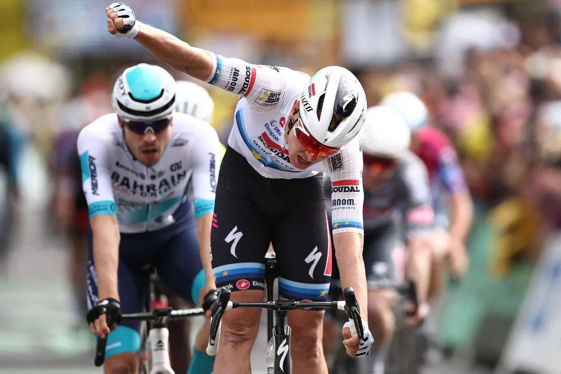 Soudal Quick-Step team's Belgian rider Tim Merlier cycles to the finish line to win the 3rd stage of the Tour de France on July 7.
