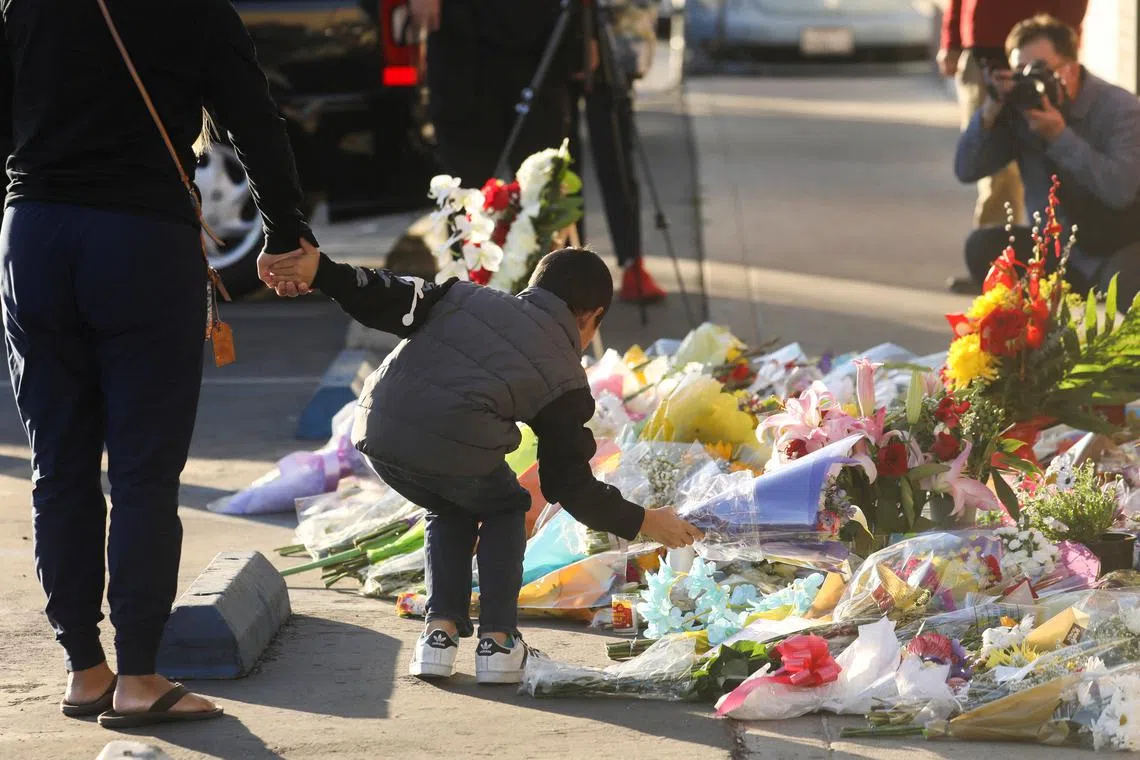 People leave flowers at the entrance of the Star Ballroom after a mass shooting during Chinese Lunar New Year celebrations in Monterey Park, California, U.S. on Jan 24, 2023. 