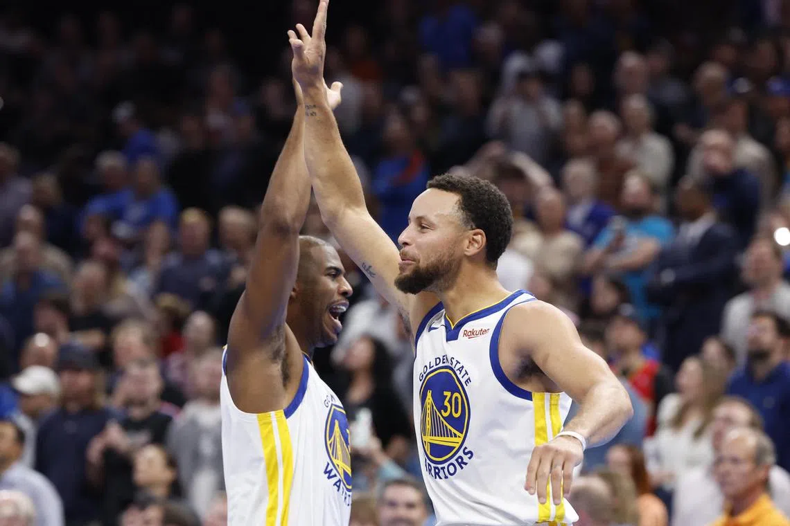 Golden State Warriors guard Stephen Curry and fellow guard Chris Paul high five after defeating the Oklahoma City Thunder at Paycom Centre. Golden State won 141-139.