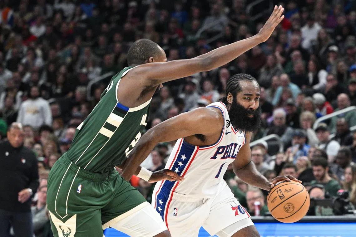 James Harden of the Philadelphia 76ers drives to the basket against the Milwaukee Bucks' Khris Middleton in the second half at Fiserv Forum.