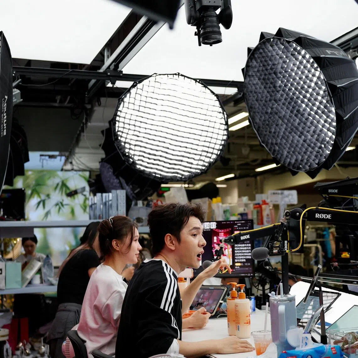 Livestreamer Li Jiaqi (in black top) is famed for selling billions of dollars worth of beauty products to more than 100 million followers.