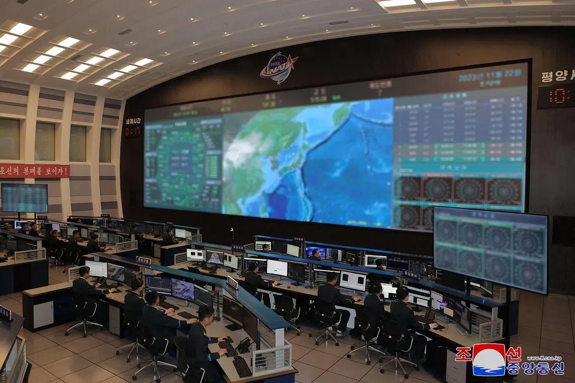 TOPSHOT - This picture taken and released on November 22, 2023 from North Korea's official Korean Central News Agency (KCNA) shows a view (screens digitally blurred as received from source) of the Pyongyang General Control Centre of the Korean National Aerospace Technology Directorate, a day after the launch of a rocket carrying the reconnaissance satellite 'Malligyong-1', in Pyongyang. North Korea said on November 22 it had succeeded in putting a military spy satellite in orbit after two previous failures, as the US led its allies in condemning the launch as a "brazen violation" of UN sanctions. (Photo by KCNA VIA KNS / AFP) / South Korea OUT / REPUBLIC OF KOREA OUT  -- NOTE: Digital blurring of screens done at source--  ---EDITORS NOTE--- RESTRICTED TO EDITORIAL USE - MANDATORY CREDIT "AFP PHOTO/KCNA VIA KNS" - NO MARKETING NO ADVERTISING CAMPAIGNS - DISTRIBUTED AS A SERVICE TO CLIENTS / THIS PICTURE WAS MADE AVAILABLE BY A THIRD PARTY. AFP CAN NOT INDEPENDENTLY VERIFY THE AUTHENTICITY, LOCATION, DATE AND CONTENT OF THIS IMAGE --- / 