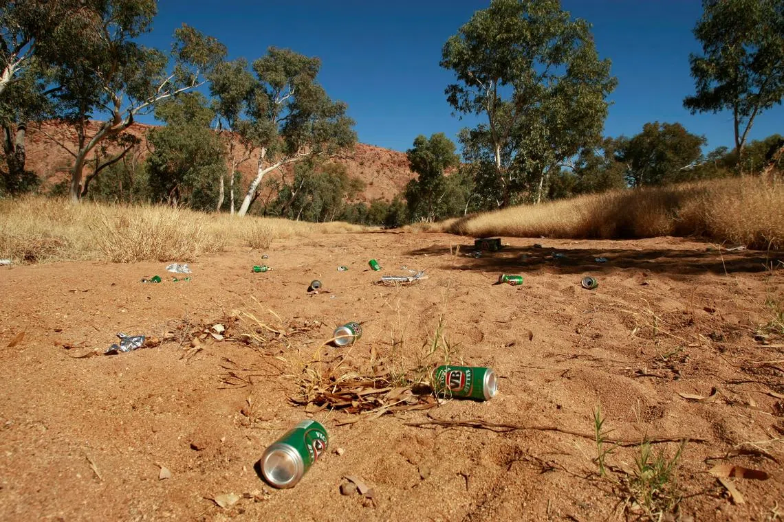 Empty beer cans lie on the Todd River's dry bed in the central Australian town of Alice Springs in this picture taken on July 5, 2007. 