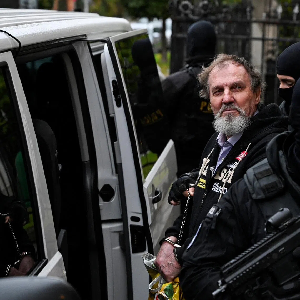 Juraj Cintula, accused of the 2024 attack on Slovak Prime Minister Robert Fico, gets into a car with security officials after the verdict on the final day of his trial, at the Specialised Criminal Court in Banska Bystrica, Slovakia, October 21, 2025. REUTERS/Radovan Stoklasa / File Photo