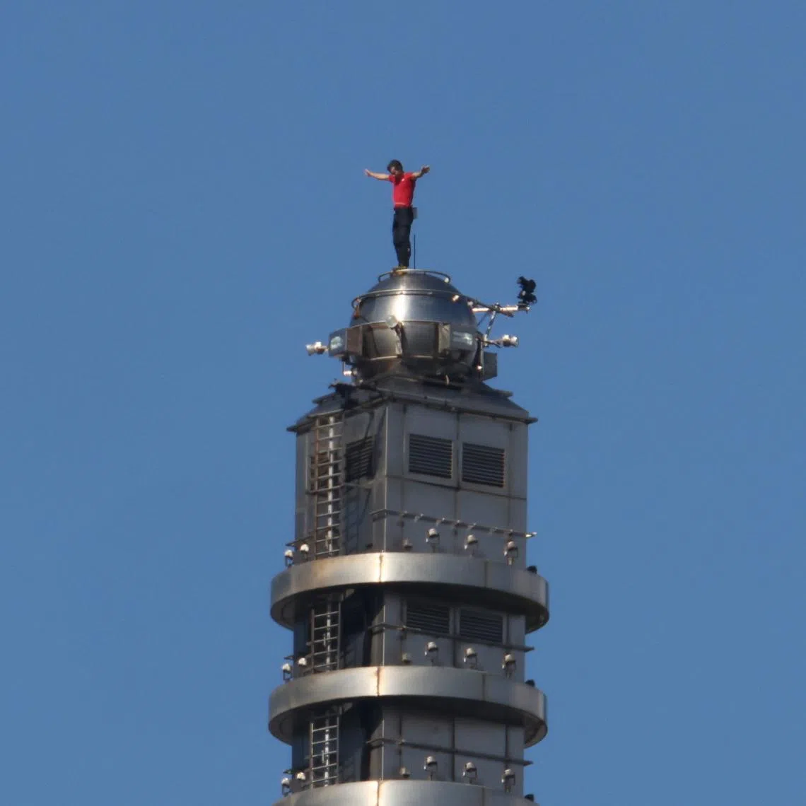 US climber Alex Honnold celebrates at the top of Taipei 101 after completing his free solo climb.