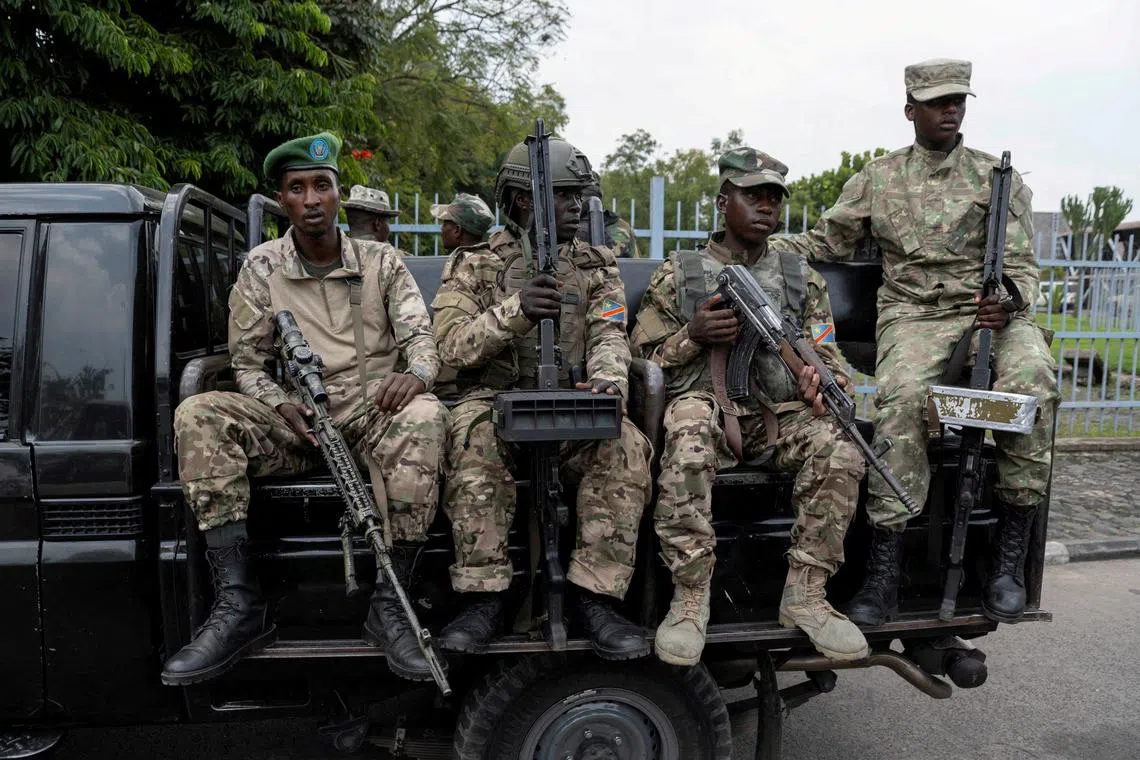 FILE PHOTO: M23 rebels sit on a truck during the escort of captured FDLR members (not pictured) to Rwanda for repatriation, at the Goma-Gisenyi Grande Barrier border crossing, March 1, 2025. REUTERS/Arlette Bashizi/File Photo