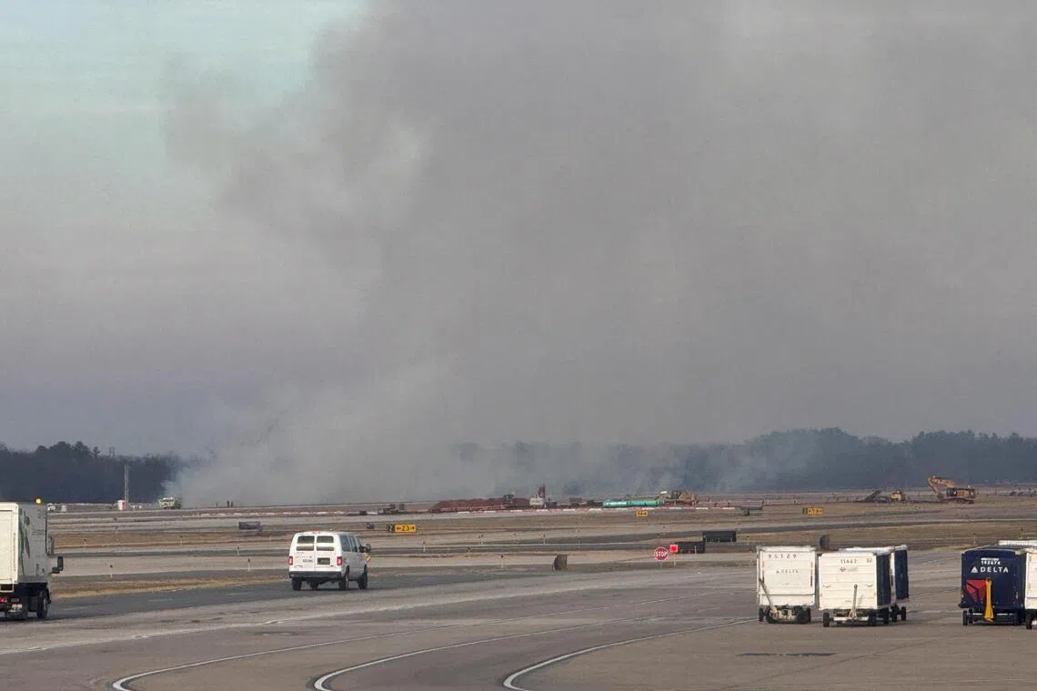 Smoke rising during an incident involving a United Airlines plane on the tarmac at Dulles International Airport, in Dulles, Virginia, on Dec 13.