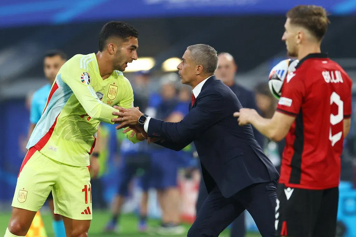 Soccer Football - Euro 2024 - Group B - Albania v Spain - Dusseldorf Arena, Dusseldorf, Germany - June 24, 2024   Spain's Ferran Torres shakes hands with Albania coach Sylvinho during the match REUTERS/Bernadett Szabo