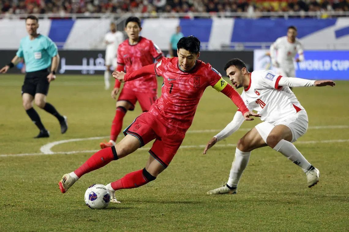 Soccer Football - World Cup - AFC Qualifiers - Third Round - Group B - South Korea v Jordan - Suwon World Cup Stadium, Suwon, South Korea - March 25, 2025 South Korea's Heung-Min Son in action with Jordan's Mohannad Abu Taha REUTERS/Kim Soo-Hyeon/File Photo
