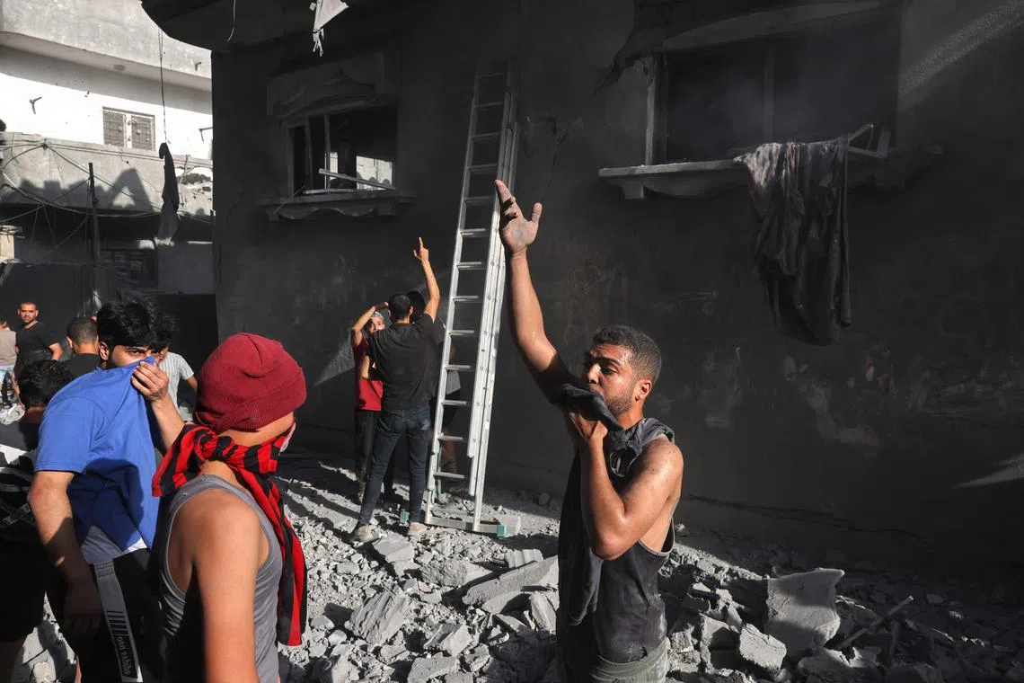 Palestinians gather at the scene of a strike at the Nuseirat refugee camp in the central Gaza Strip on Nov 4.