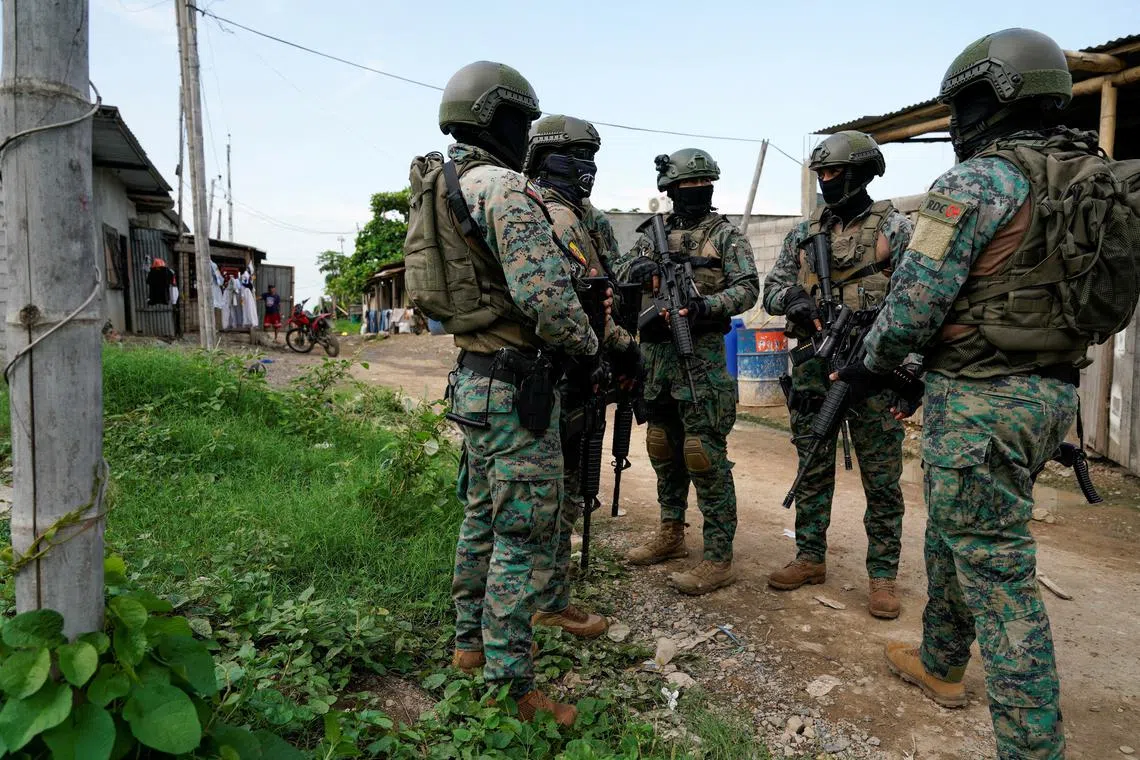 FILE PHOTO: Soldiers stand together during a joint police and military operation in a low-income neighbourhood, as the government continues its offensive against criminal gangs, in Duran, Ecuador, February 1, 2024. REUTERS/Santiago Armas/File Photo