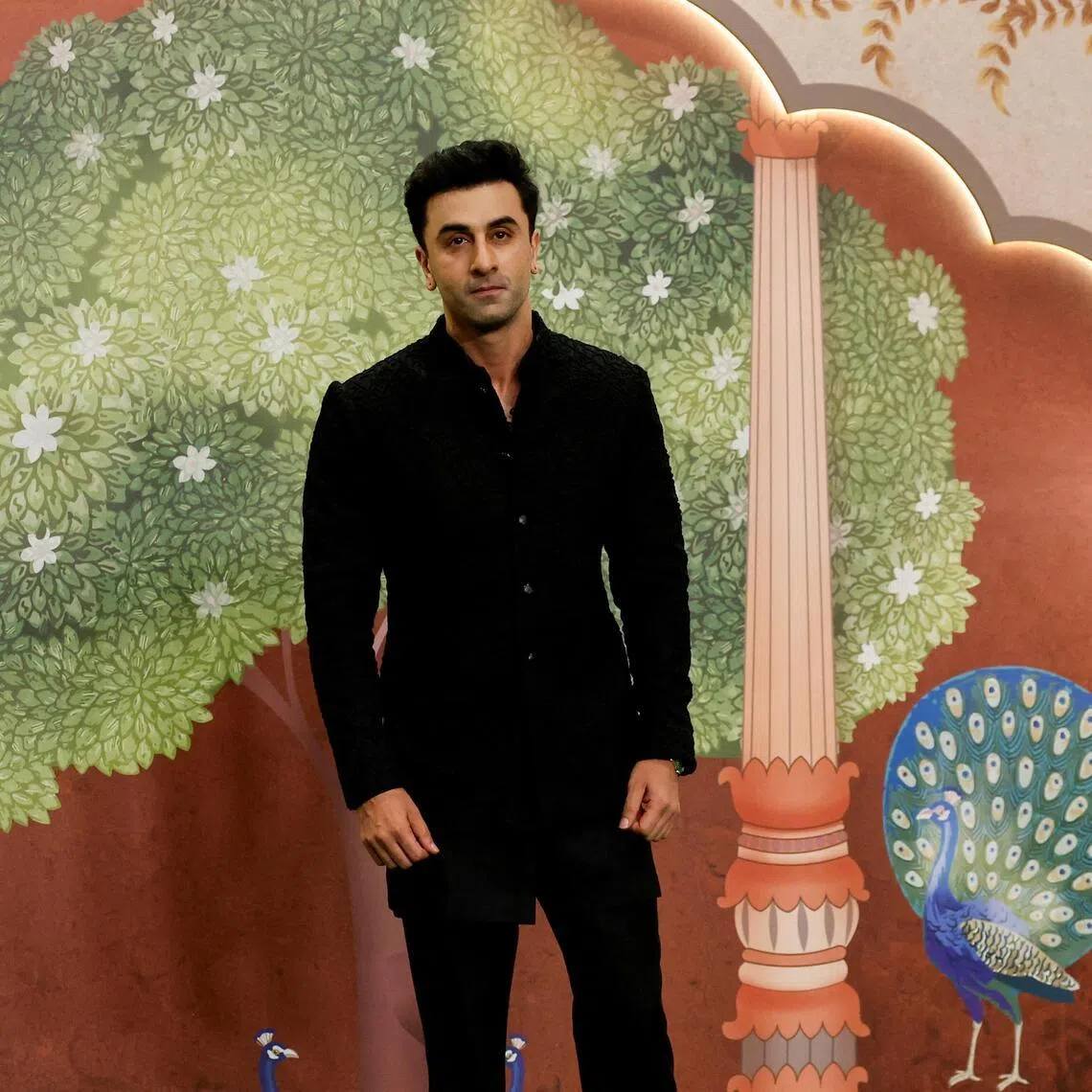 Bollywood actor Ranbir Kapoor poses for pictures on the red carpet as he attends the blessing ceremony of Anant Ambani and Radhika Merchant after their marriage in Mumbai, India, July 13, 2024.