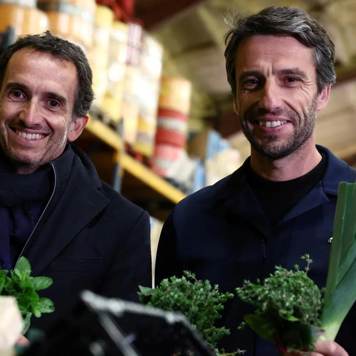 Alexandre Bompard, Chairman and Chief Executive Officer of French retailer Carrefour, and Tony Estanguet, President of the Organising Committee of the Paris 2024 Olympic and Paralympic Games,  pose with herbs and vegetables during a visit at the Vaulerand potato farm as French supermarket giant and Paris 2024 sponsor Carrefour presents its strategy to provide fresh products for athletes during the Paris 2024 Olympic and Paralympic Games, in Villeron, near Paris, France, April 18, 2024. REUTERS/Stephanie Lecocq