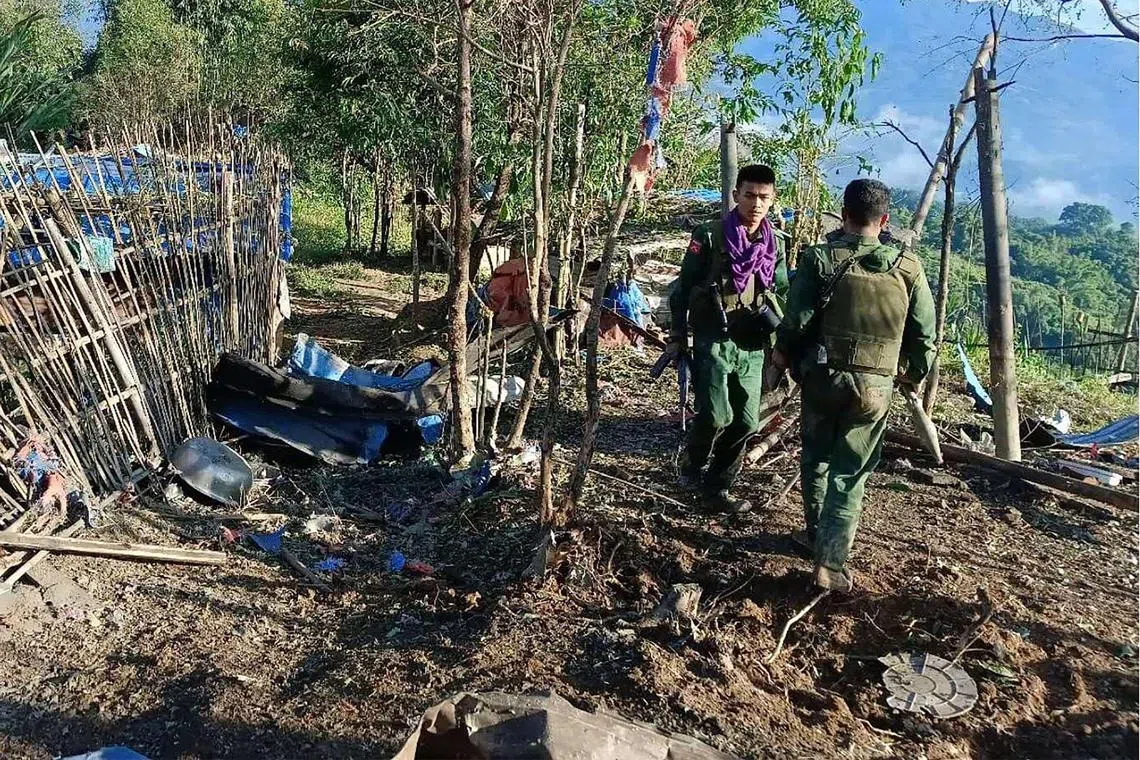 Members of the Myanmar National Democratic Alliance Army walking past a Myanmar military base after seizing it during clashes near Laukkai township in Myanmar’s northern Shan state. 