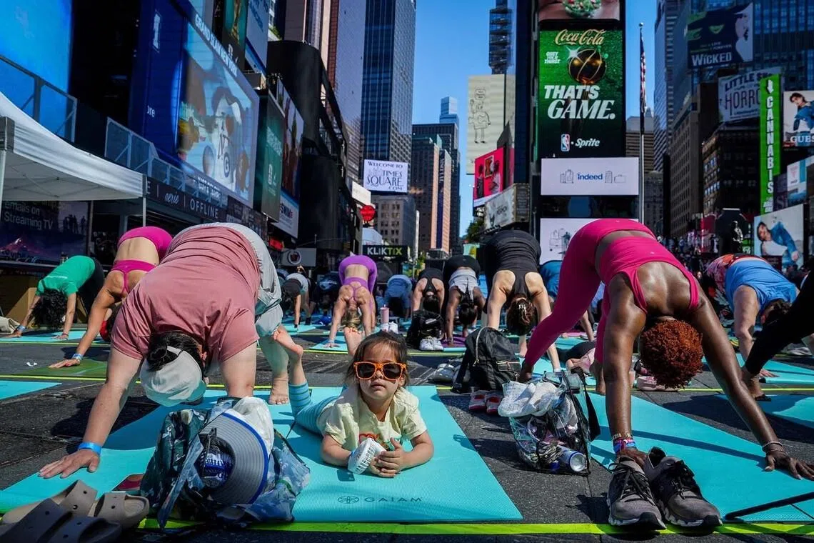 Yogis participating in a yoga class during the 24th annual Solstice In Times Square: Mind Over Madness Yoga event to celebrate the summer solstice in New York City, US, on June 21. 
