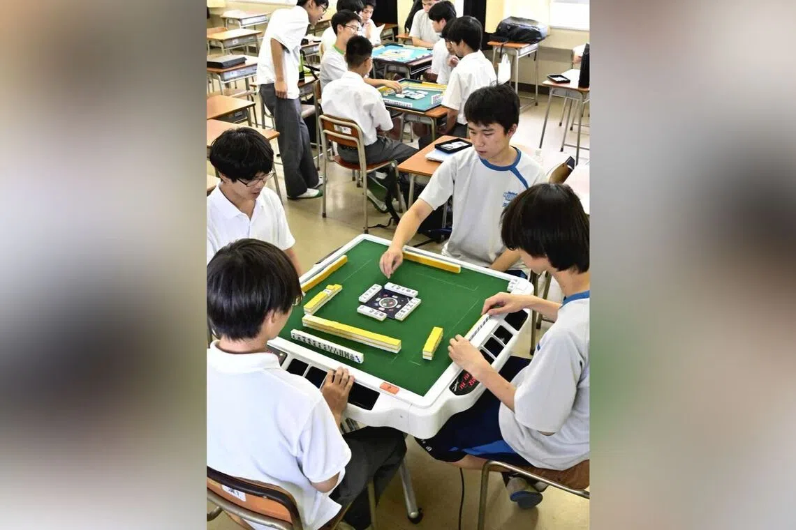 Students of the mahjong club at Kishine High School play the tile-based game in Yokohama, Japan, on July 15, 2025.
