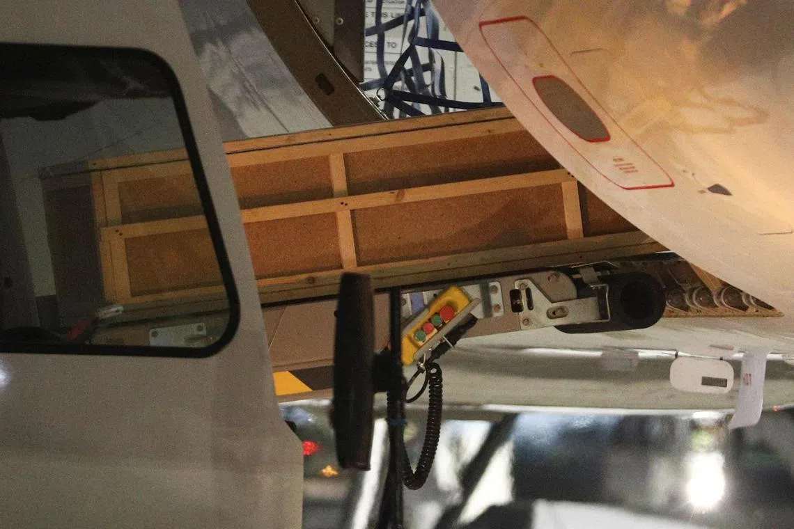 A coffin with the body of a victim of the Azerbaijan Airlines' Embraer passenger aircraft crash near the Kazakh city of Aktau, is transported out of a plane upon the arrival at an airport in Baku, Azerbaijan, December 26, 2024. REUTERS/Aziz Karimov